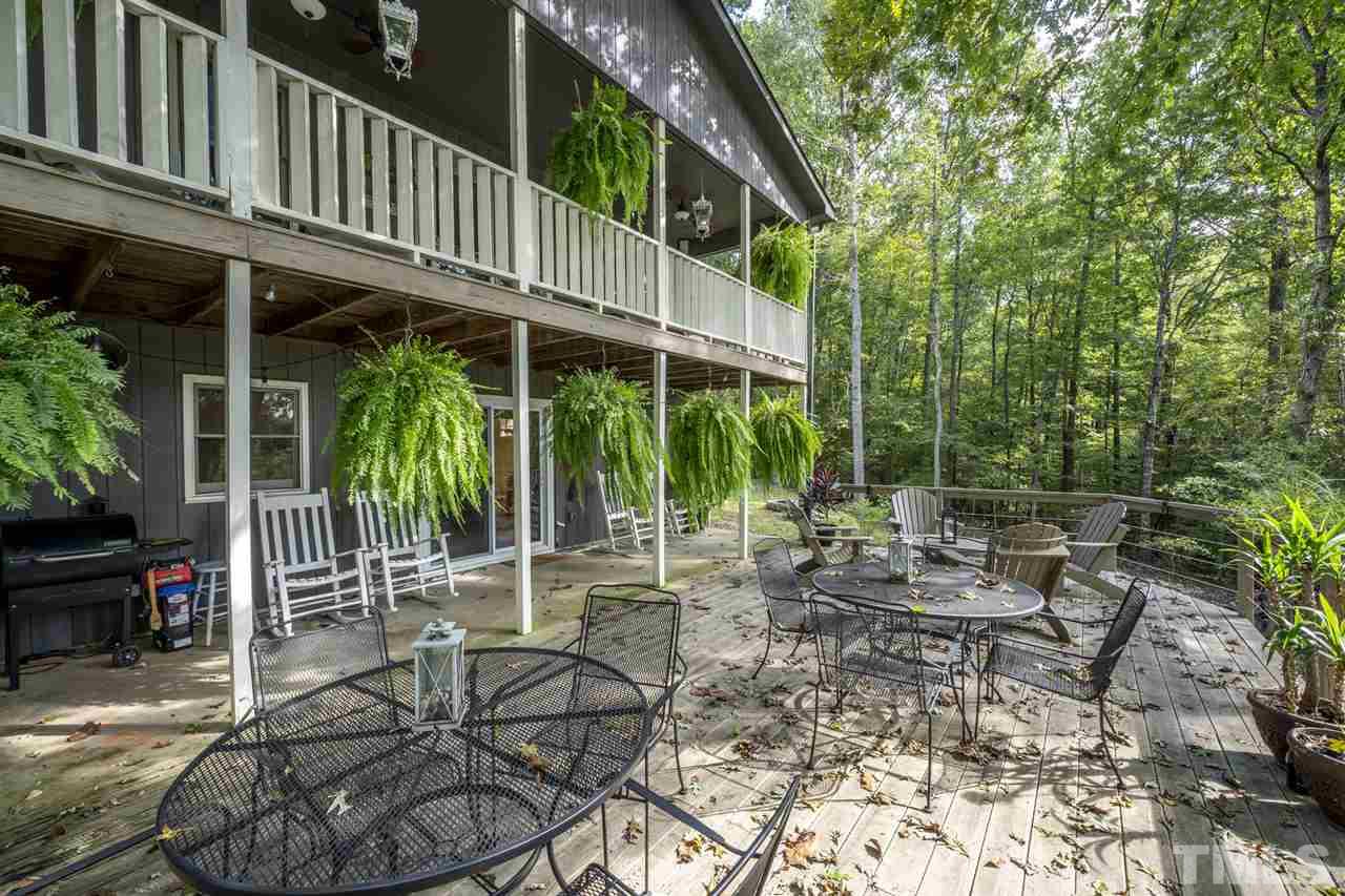 167 Hidden Hills Road Roxboro, NC 27574 - Photo 12 of 25 a view of a patio with table and chairs and potted plants