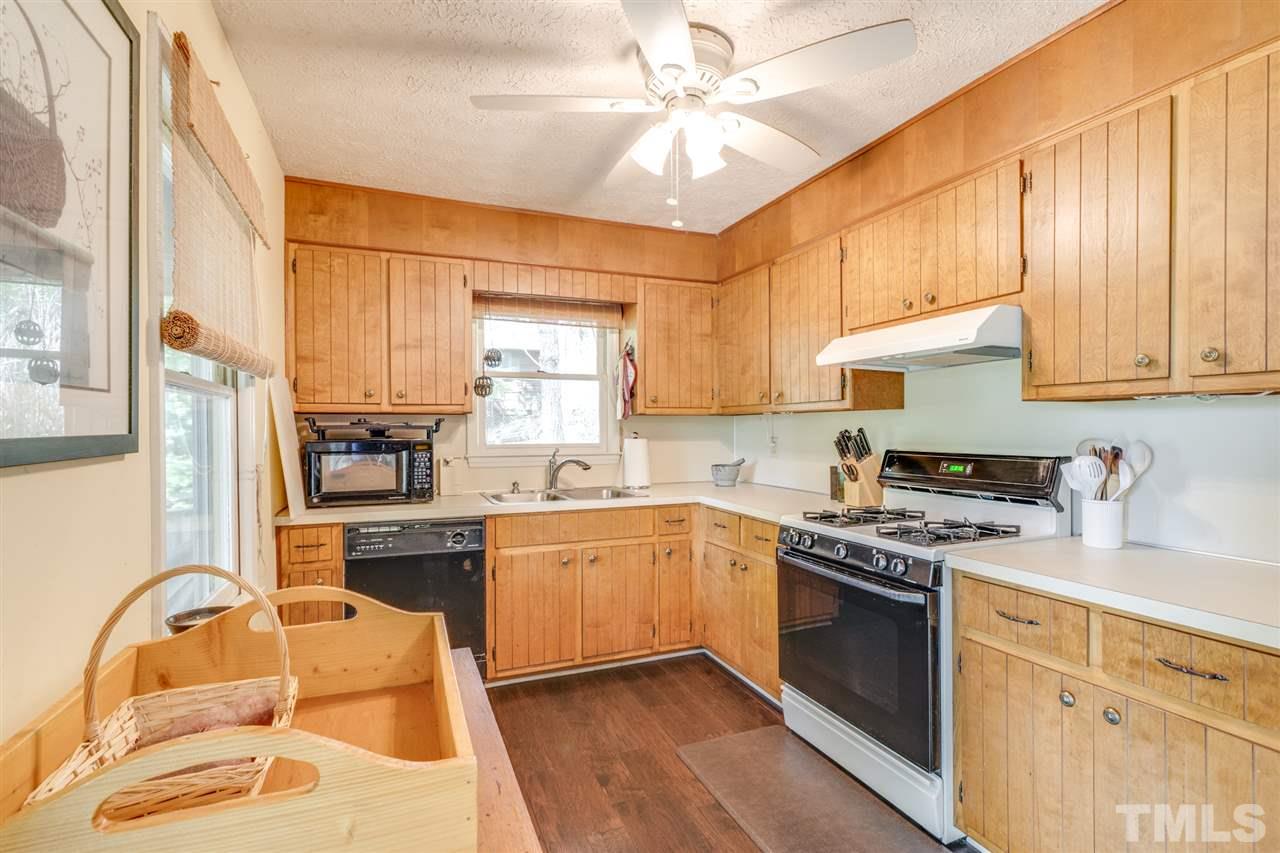 167 Hidden Hills Road Roxboro, NC 27574 - Photo 14 of 25 a kitchen with stainless steel appliances granite countertop a stove sink and cabinets