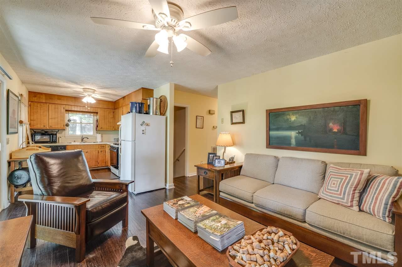 167 Hidden Hills Road Roxboro, NC 27574 - Photo 15 of 25 a living room with furniture and a chandelier