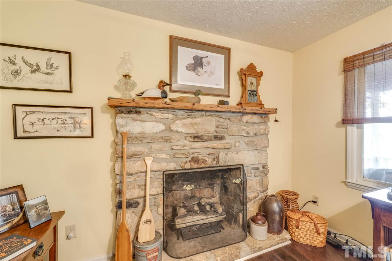 167 Hidden Hills Road Roxboro, NC 27574 - Photo 16 of 25 a living room with furniture and a fireplace