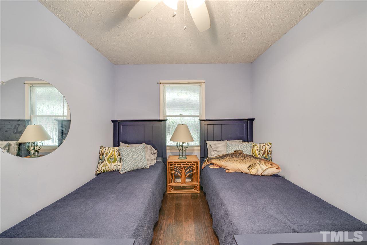 167 Hidden Hills Road Roxboro, NC 27574 - Photo 19 of 25 a view of a bedroom with bed and mirror