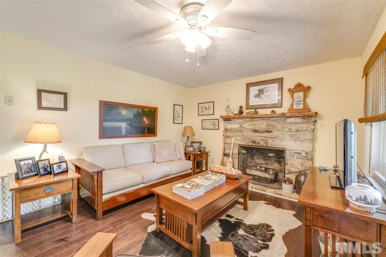 167 Hidden Hills Road Roxboro, NC 27574 - Photo 25 of 25 a living room with furniture and a fireplace
