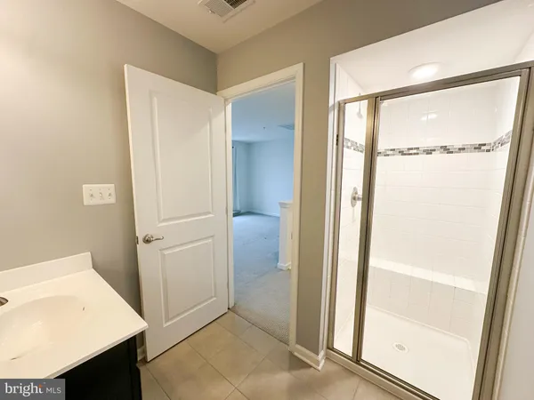 a bathroom with a double vanity sink toilet and mirror