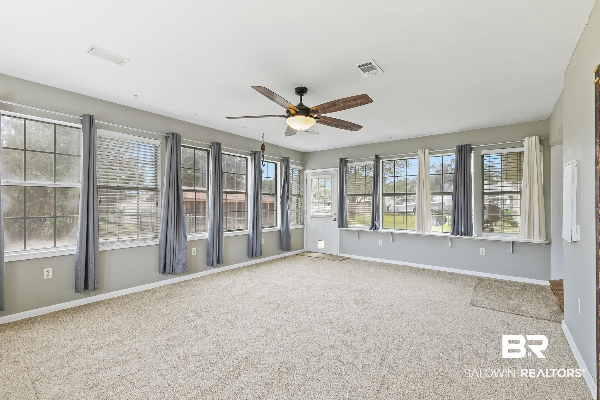13108 6th Street Lillian, AL 36549 - Photo 18 of 39 Unfurnished sunroom featuring ceiling fan and a wealth of natural light