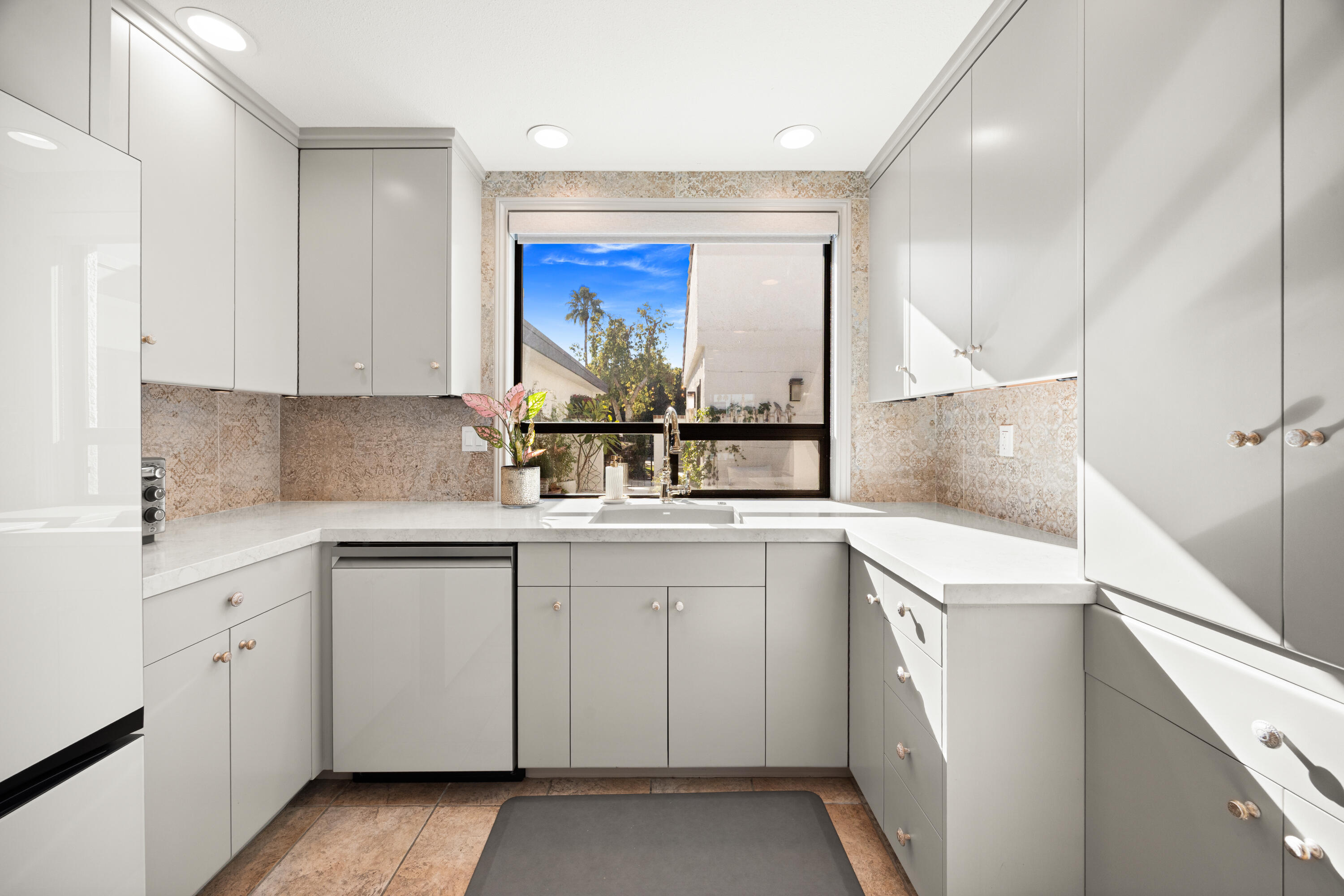 53 Marbella Drive Rancho Mirage, CA 92270 - Photo 13 of 45 a kitchen with granite countertop white cabinets and white appliances