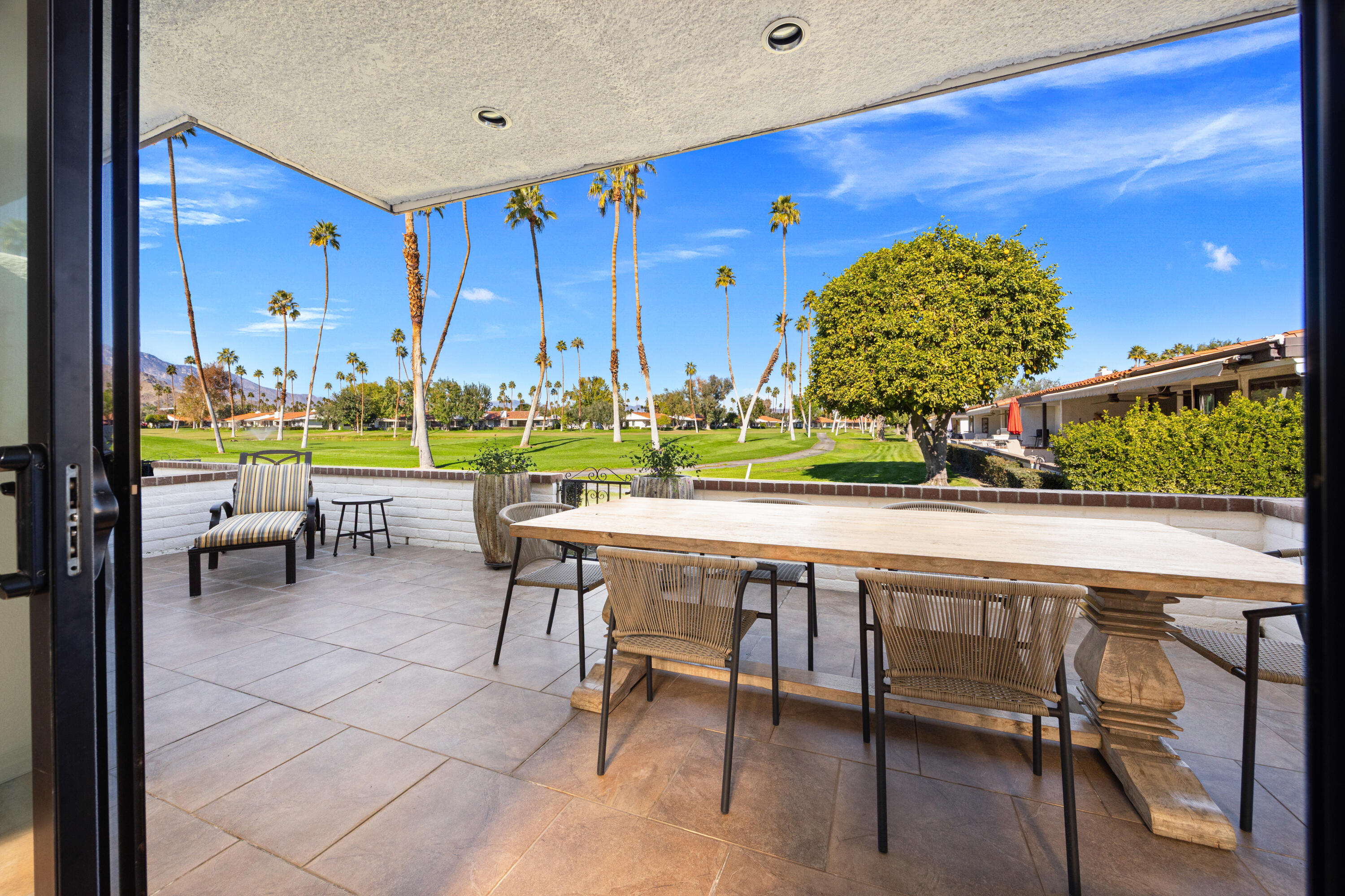 53 Marbella Drive Rancho Mirage, CA 92270 - Photo 28 of 45 a view of a chairs and table in a patio