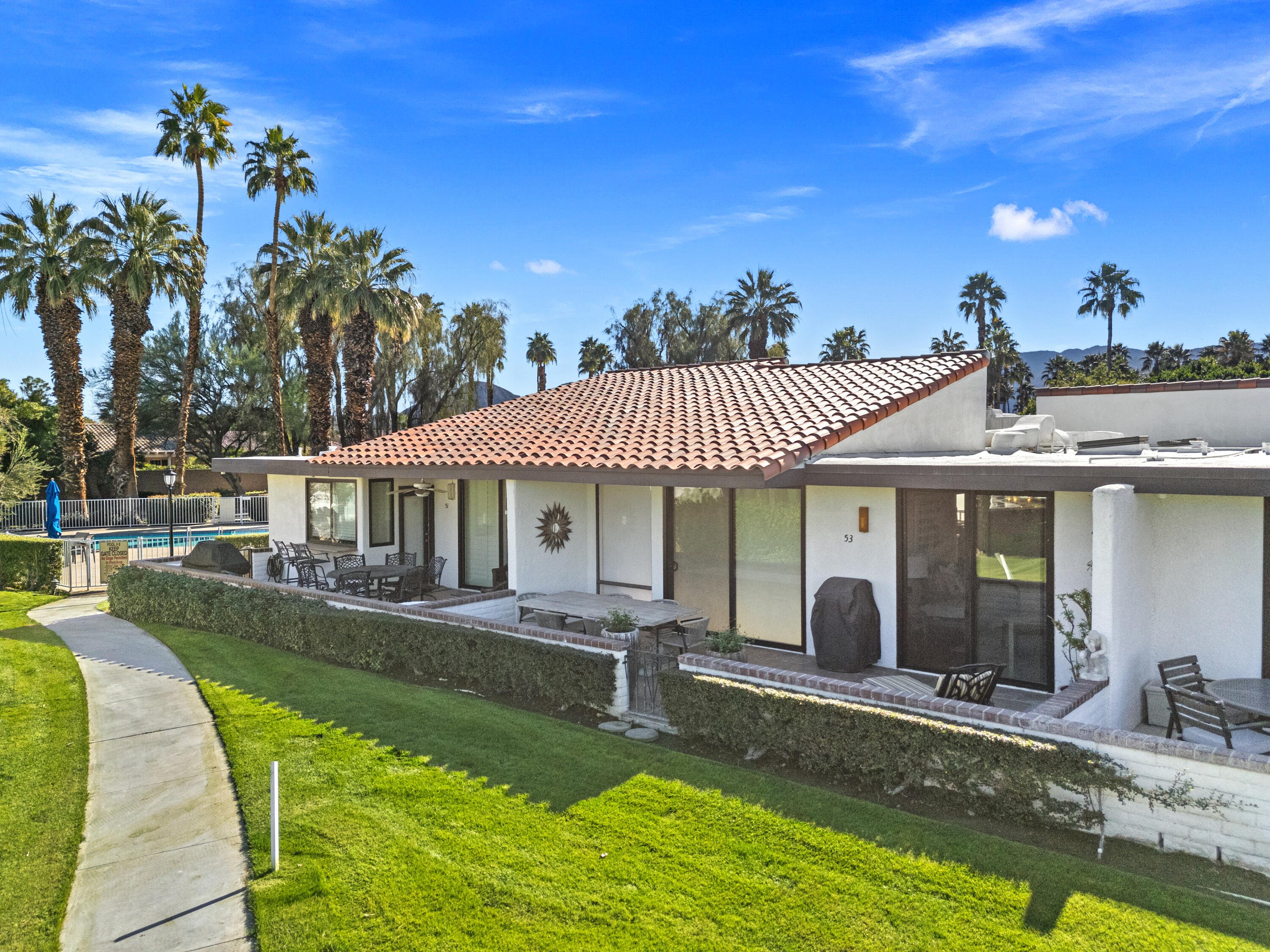 53 Marbella Drive Rancho Mirage, CA 92270 - Photo 36 of 45 a view of a house with swimming pool and a porch