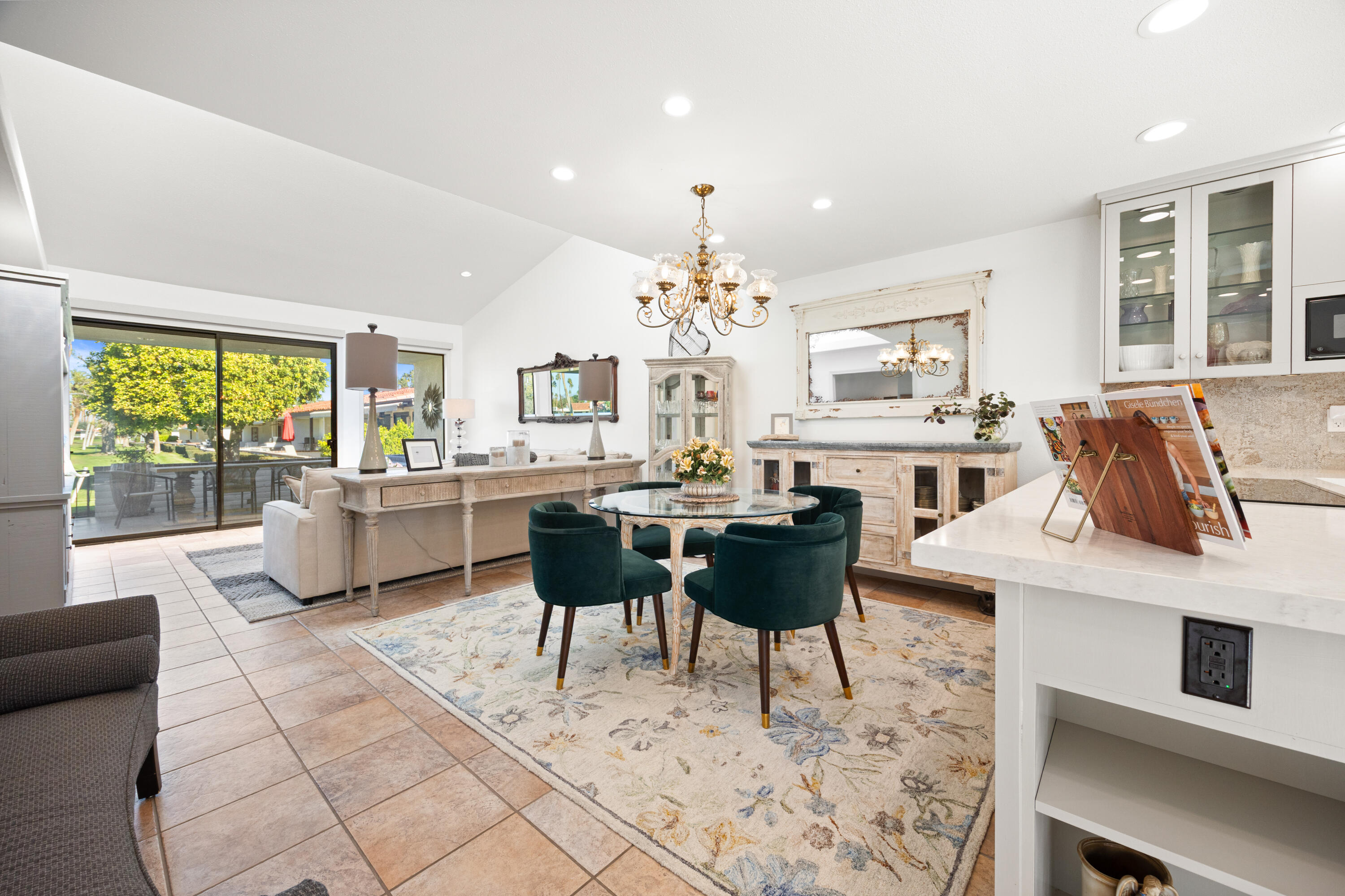 53 Marbella Drive Rancho Mirage, CA 92270 - Photo 9 of 45 a living room with furniture a chandelier and a dining table with kitchen view