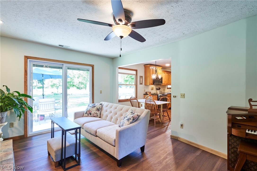 1121 Novak Road Grafton, OH 44044 - Photo 14 of 37 Living room featuring plenty of natural light, ceiling fan with notable chandelier, and dark hardwood / wood-style flooring