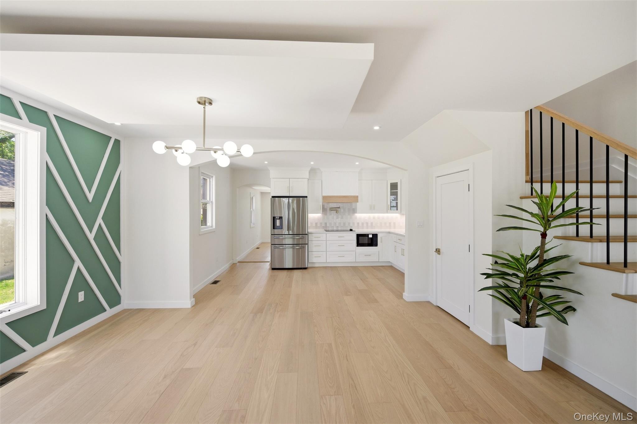 135 Whaley Street Freeport, NY 11520 - Photo 12 of 38 a view of a room with wooden floor and potted plant