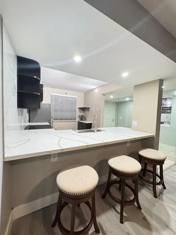 a kitchen with a table and chairs in it