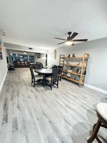 a work room with furniture and a wooden floor