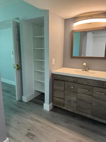 a bathroom with a double vanity sink and mirror