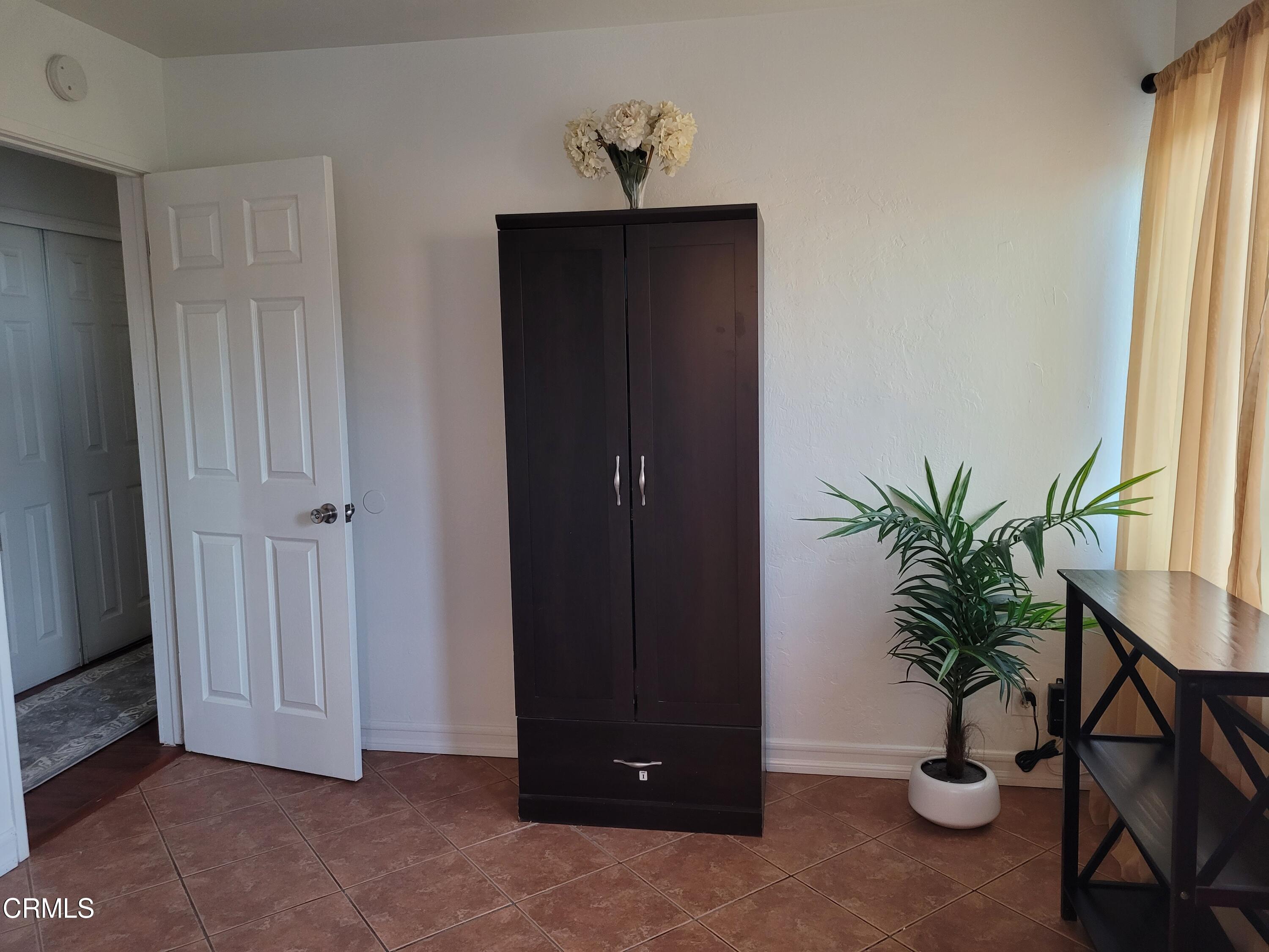 521 West Bard Road Oxnard, CA 93033 - Photo 4 of 19 a view of a hallway with potted plant and a window