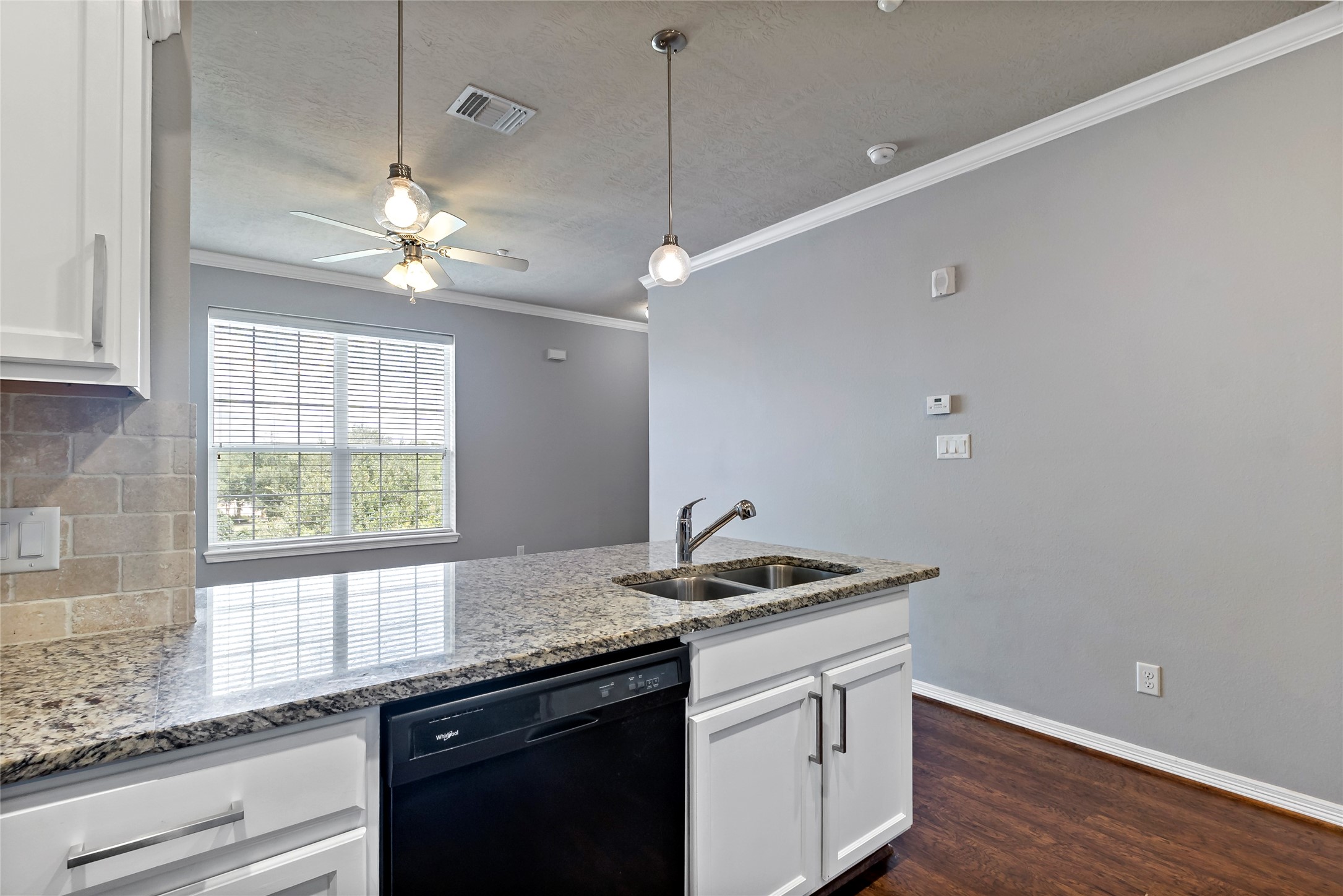 1198 Jones-Butler Road, Unit 1402 College Station, TX 77840 - Photo 16 of 21 a kitchen with a sink and dishwasher with wooden floor