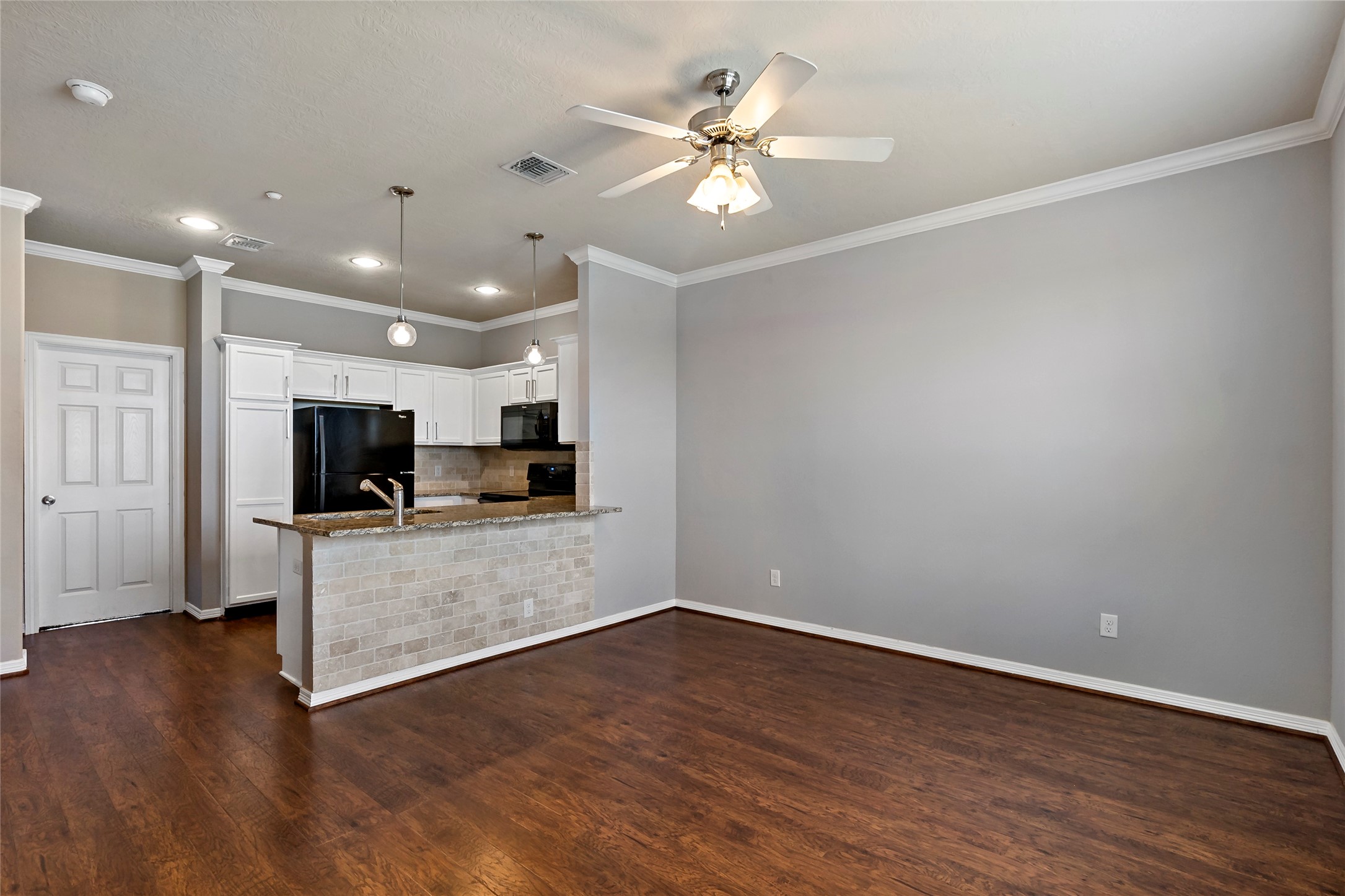 1198 Jones-Butler Road, Unit 1402 College Station, TX 77840 - Photo 20 of 21 a view of a livingroom with furniture wooden floor and a ceiling fan