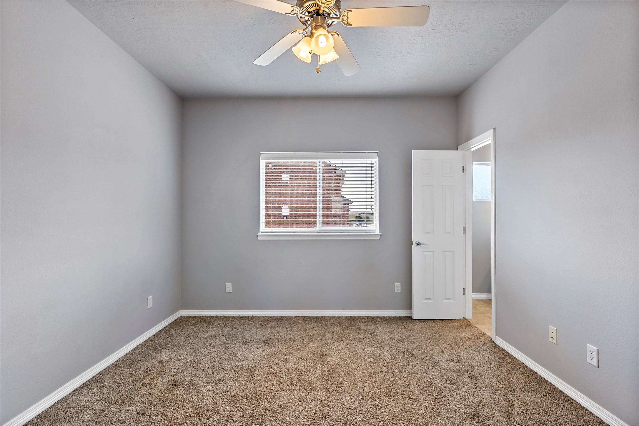 1198 Jones-Butler Road, Unit 1402 College Station, TX 77840 - Photo 21 of 21 an empty room with windows and chandelier fan
