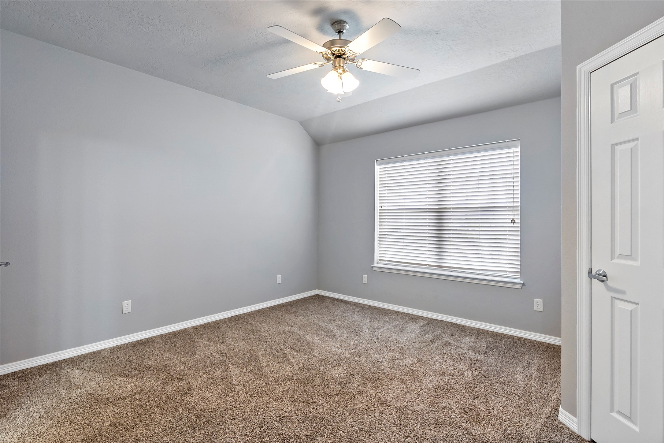 1198 Jones-Butler Road, Unit 1402 College Station, TX 77840 - Photo 10 of 21 an empty room with windows and ceiling fan