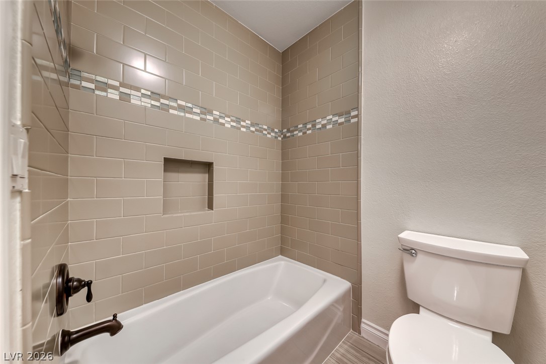 2122 Mooreview Street Henderson, NV 89012 - Photo 31 of 44 A well-appointed bathroom featuring subway tile surrounds and a convenient tub/shower combination.