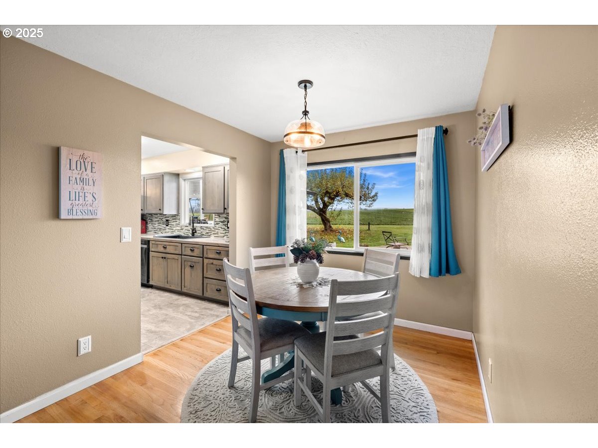 39449 Northwest Wilkesboro Road Banks, OR 97106 - Photo 11 of 45 a dining room with furniture a chandelier and window