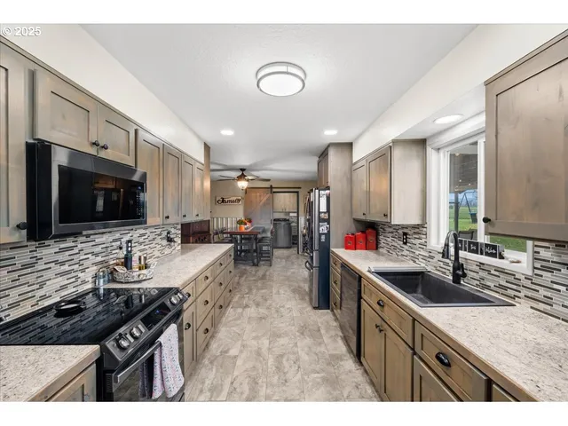 a kitchen with sink stove and cabinets