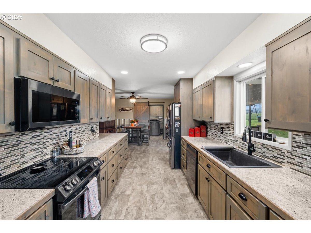 39449 Northwest Wilkesboro Road Banks, OR 97106 - Photo 12 of 45 a kitchen with sink stove and cabinets