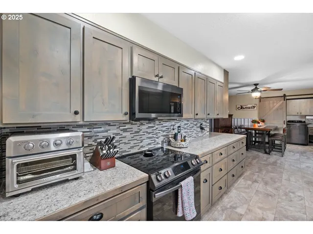 a kitchen with stainless steel appliances stove microwave and cabinets