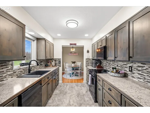 a kitchen with sink stove and cabinets