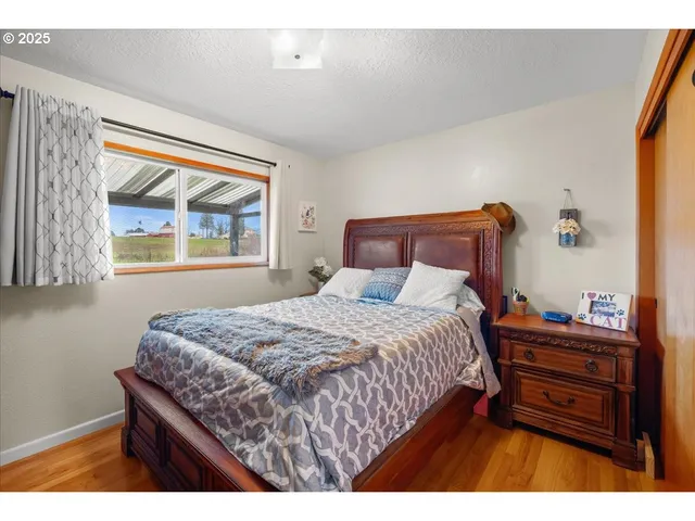 a bedroom with a bed table and window