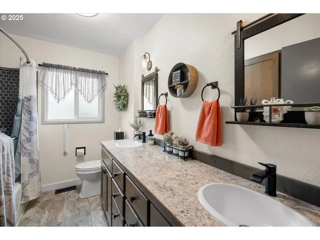 a bathroom with a granite countertop sink mirror and vanity