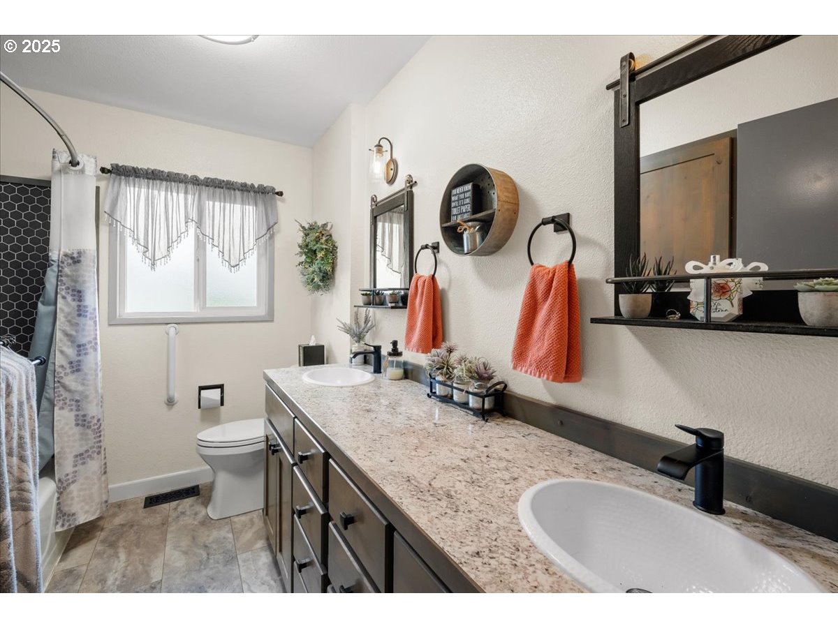 39449 Northwest Wilkesboro Road Banks, OR 97106 - Photo 24 of 45 a bathroom with a granite countertop sink mirror and vanity