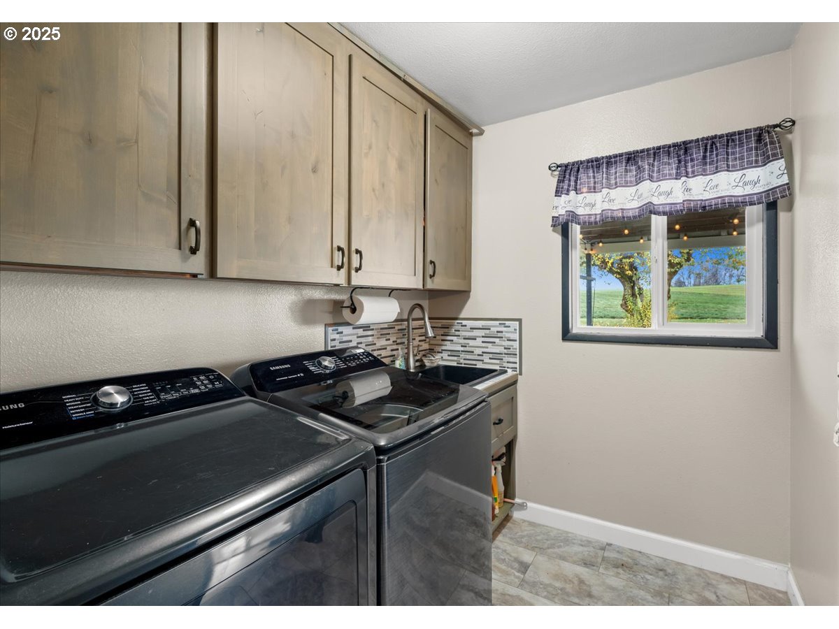 39449 Northwest Wilkesboro Road Banks, OR 97106 - Photo 28 of 45 a kitchen with a sink cabinets and a stove top oven