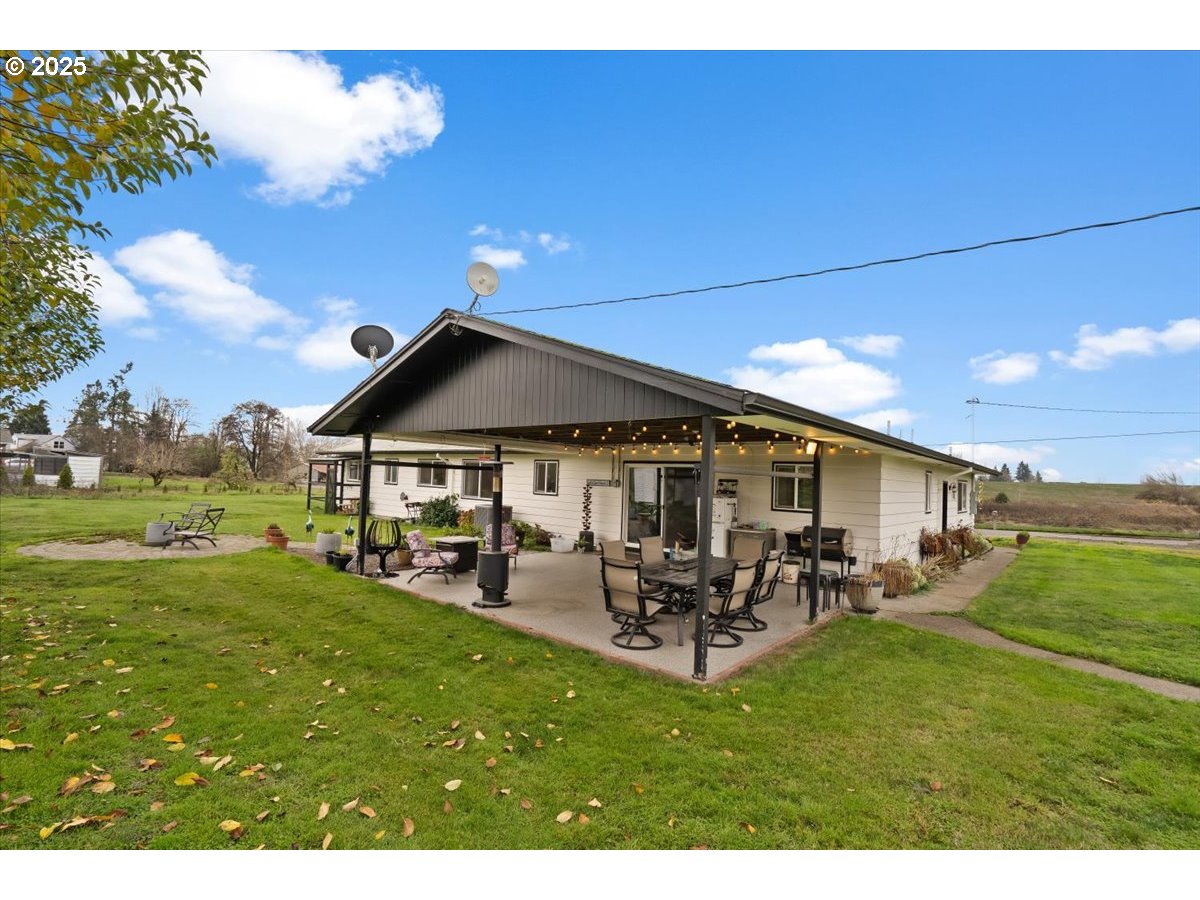 39449 Northwest Wilkesboro Road Banks, OR 97106 - Photo 30 of 45 a view of a patio with table and chairs with plants and wooden fence
