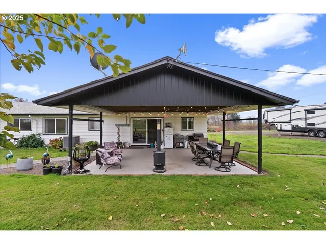 a front view of house with outdoor seating and yard