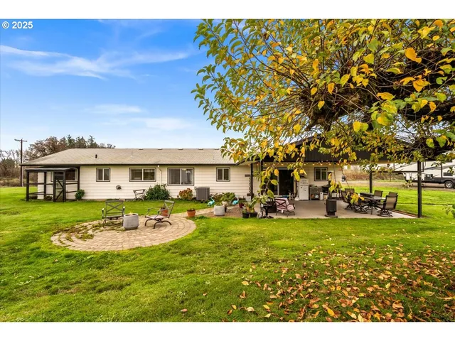 a view of a house with swimming pool and sitting area