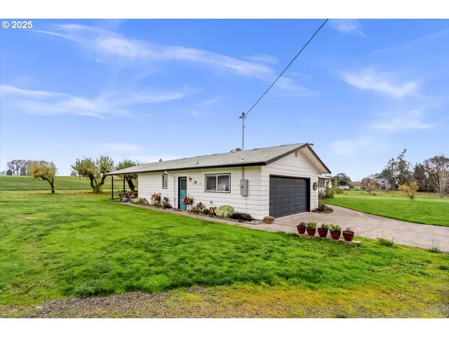 a front view of house with yard and green space