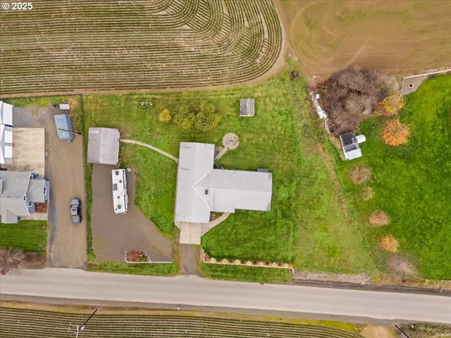 an aerial view of a house with a yard