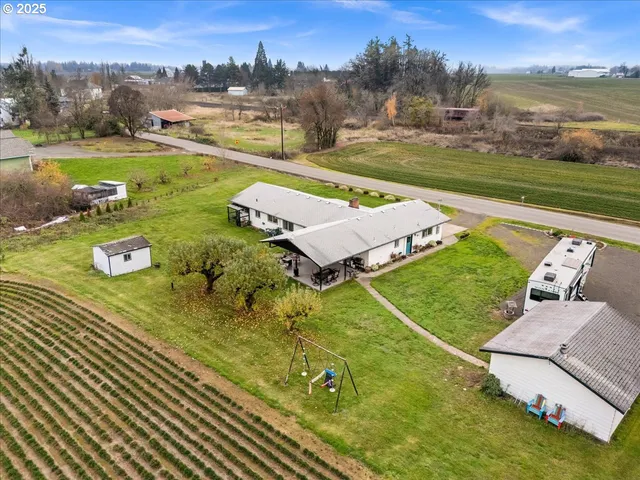 an aerial view of a house with a big yard