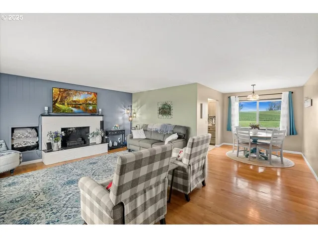 a living room with fireplace furniture and a flat screen tv