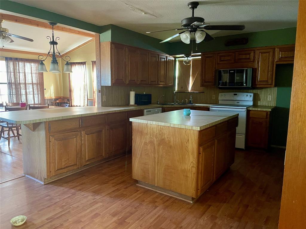 333 Spring Valley Street Hutto, TX 78634 - Photo 5 of 19 a kitchen with stainless steel appliances granite countertop a sink and a stove