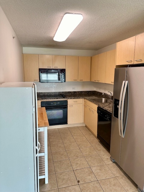 800 Elgin Road, Unit 1414 Evanston, IL 60201 - Photo 3 of 9 a kitchen with stainless steel appliances granite countertop a refrigerator a sink and a stove