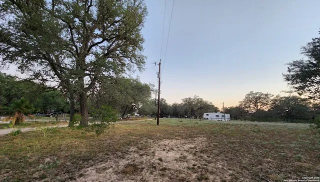 a view of outdoor space with green field and trees