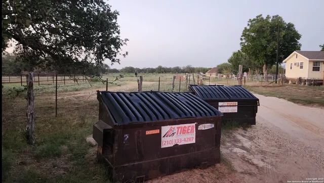 a view of a street with wooden fence