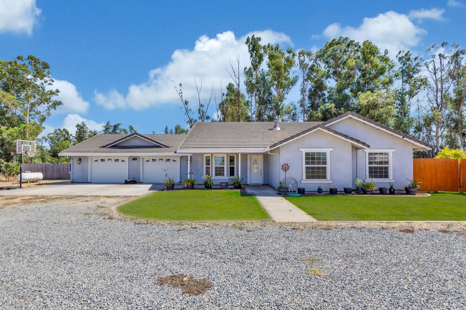 4192 Liberty Road Galt, CA 95632 - Photo 1 of 1 a front view of a house with a yard and garage