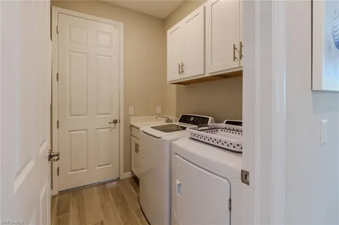 a dining room with furniture and a floor to ceiling window