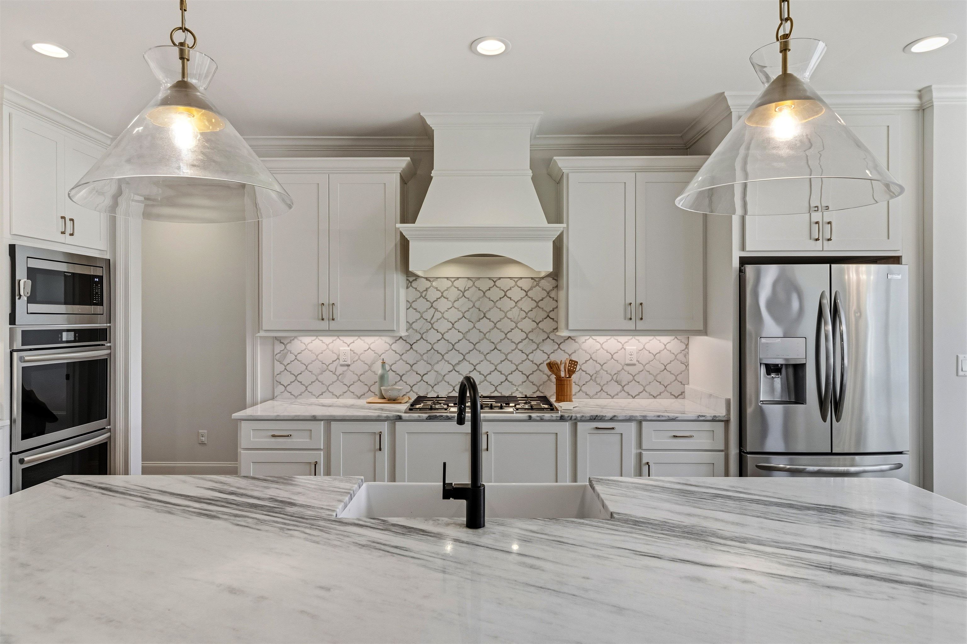 4757 Carousel Lane Collierville, TN 38017 - Photo 13 of 39 Kitchen featuring stainless steel appliances, decorative light fixtures, and white cabinets