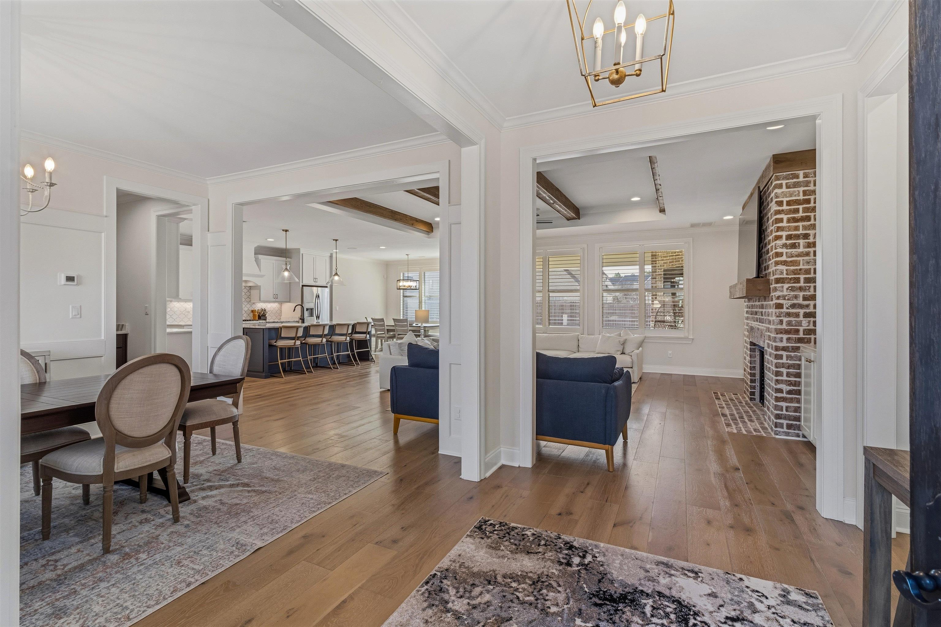 4757 Carousel Lane Collierville, TN 38017 - Photo 4 of 39 Foyer featuring a chandelier, light wood-type flooring, ornamental molding, and a fireplace