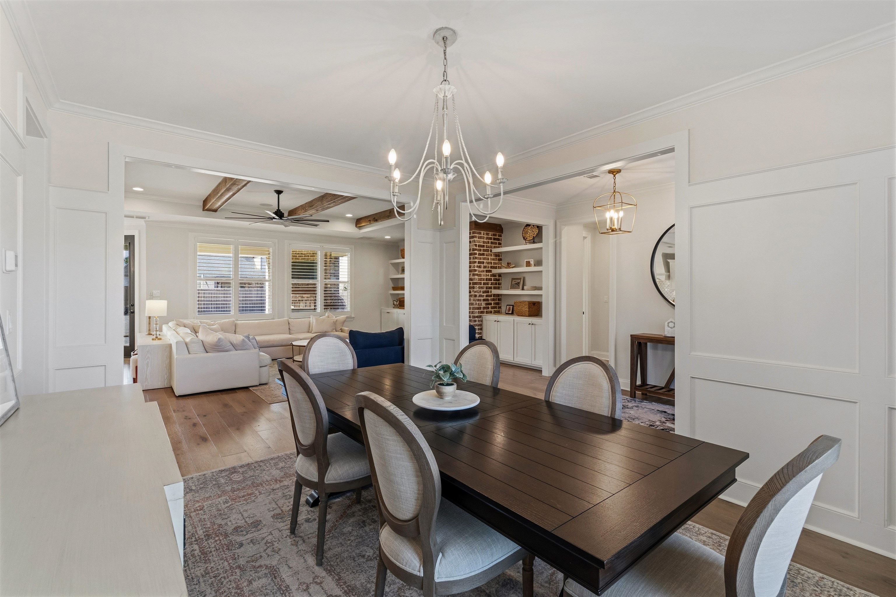 4757 Carousel Lane Collierville, TN 38017 - Photo 6 of 39 Dining room featuring wood finished floors, crown molding, built in shelves, a ceiling fan, and hanging lights