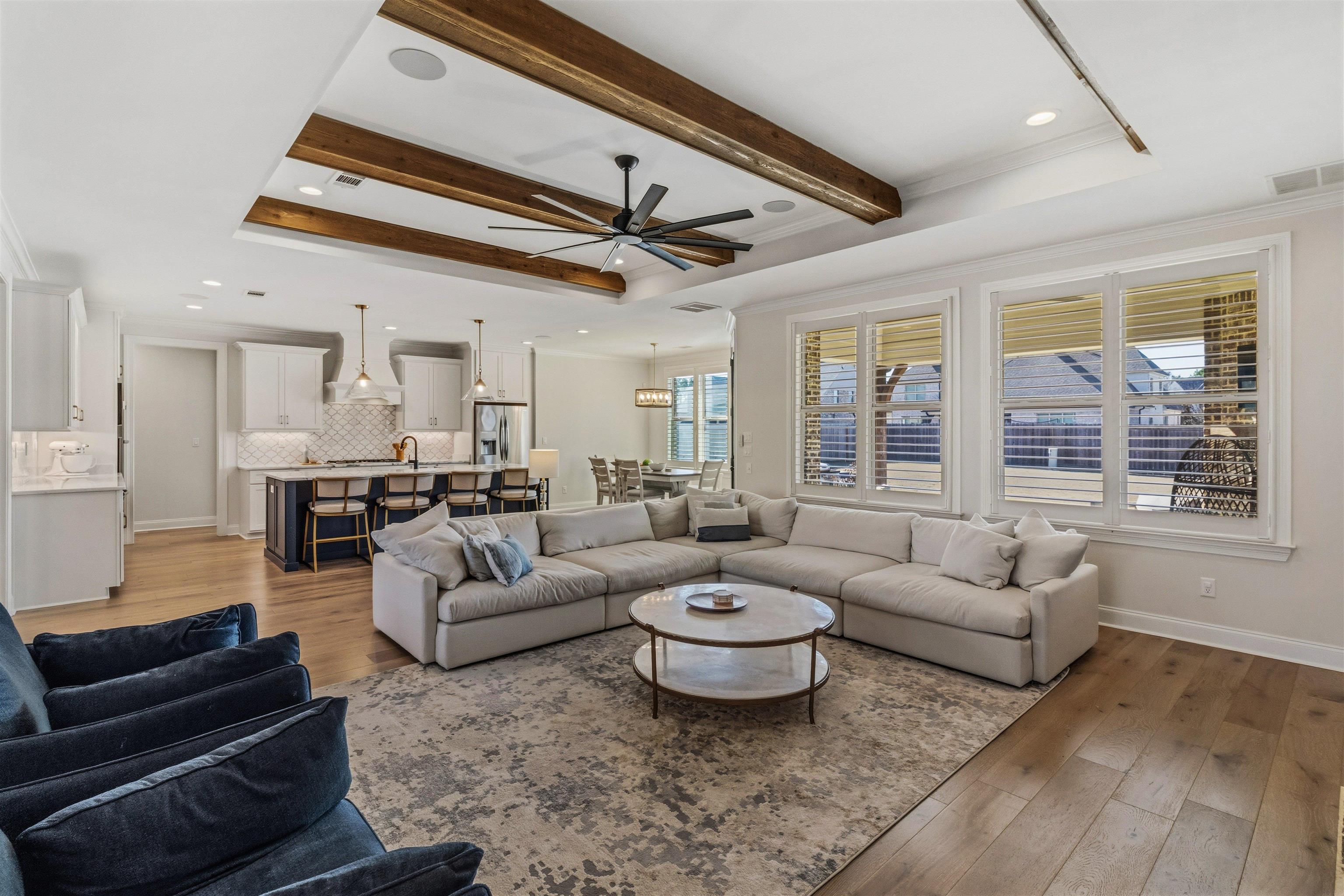 4757 Carousel Lane Collierville, TN 38017 - Photo 7 of 39 Living area with light wood-style flooring, ceiling fan, recessed lighting, a tray ceiling, and crown molding