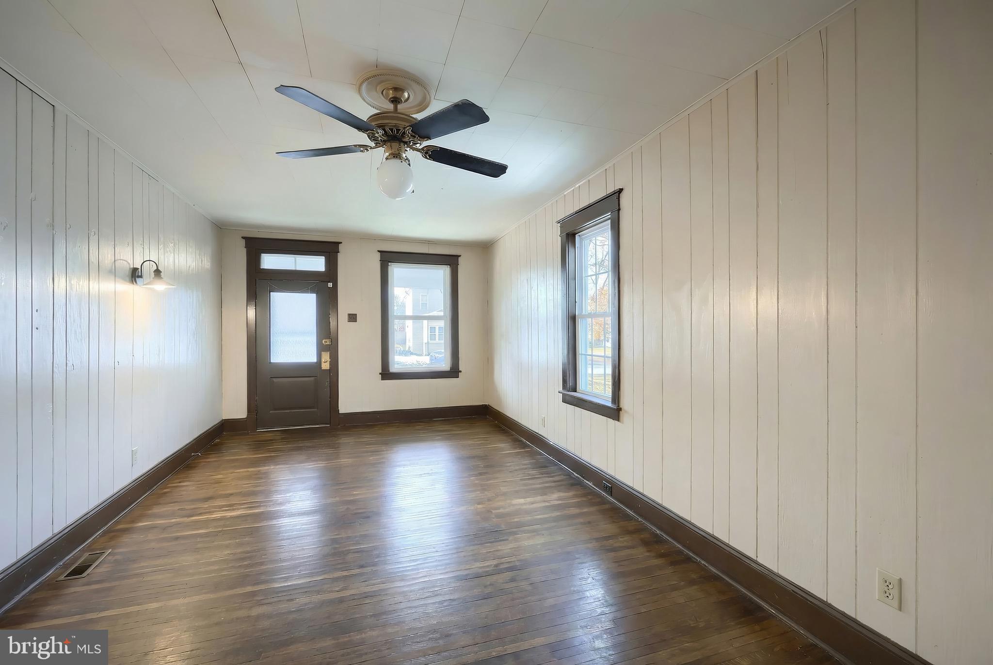 52 South Third Street Mount Wolf, PA 17347 - Photo 11 of 28 a view of an empty room with wooden floor and a window